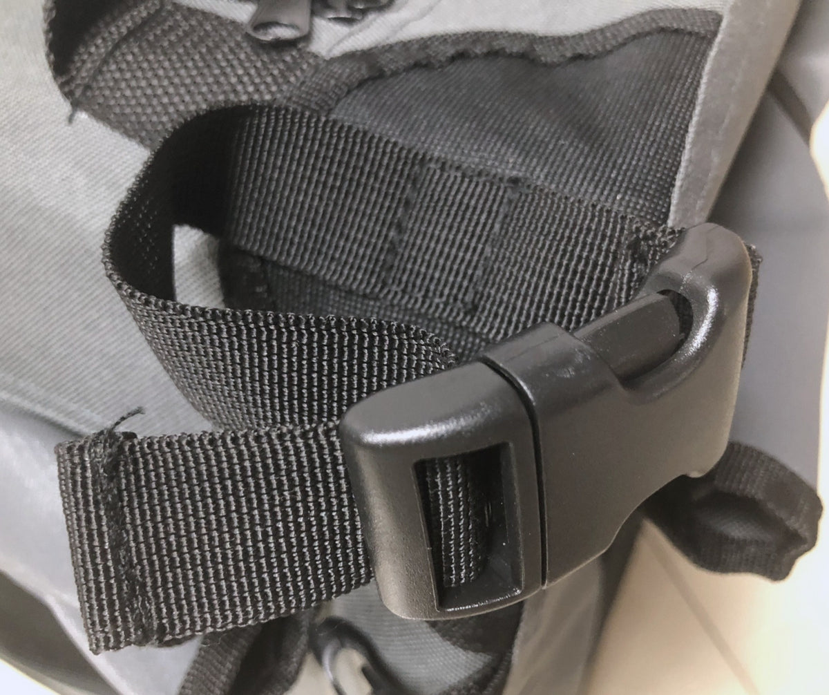 Close-up of the adjustable strap and buckle on the Ruff N Tuff canvas dog crate